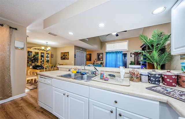 kitchen with light wood-type flooring, sink, white cabinetry, and dishwasher