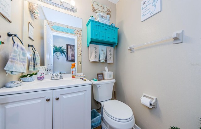 bathroom with toilet and vanity