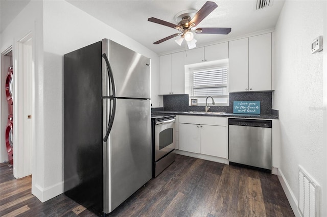 kitchen featuring dark hardwood / wood-style flooring, sink, appliances with stainless steel finishes, and ceiling fan