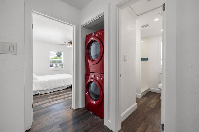 hall with dark hardwood / wood-style flooring and stacked washer / dryer