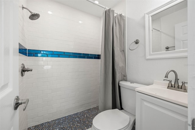 bathroom featuring toilet, vanity, and a shower with shower curtain