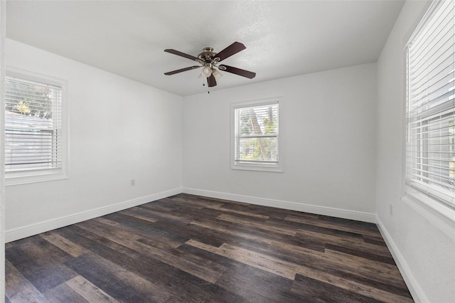 unfurnished room with ceiling fan and dark wood-type flooring