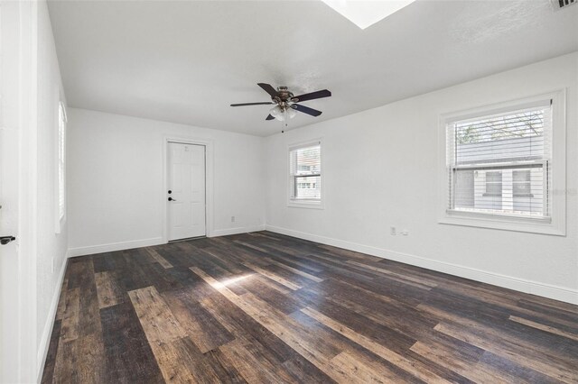 spare room with ceiling fan and dark wood-type flooring