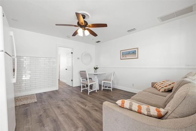 living room with ceiling fan and wood-type flooring