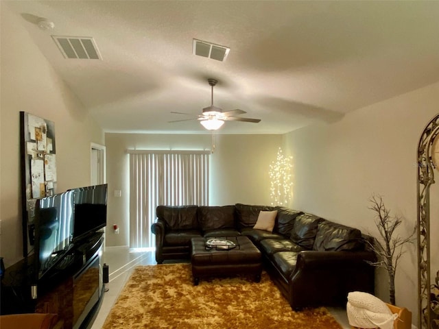 living room featuring ceiling fan, wood-type flooring, and lofted ceiling