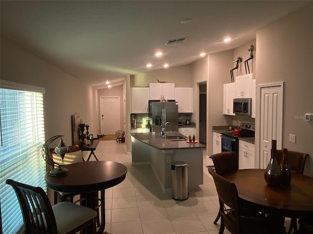 kitchen with white cabinetry, sink, stainless steel appliances, and lofted ceiling