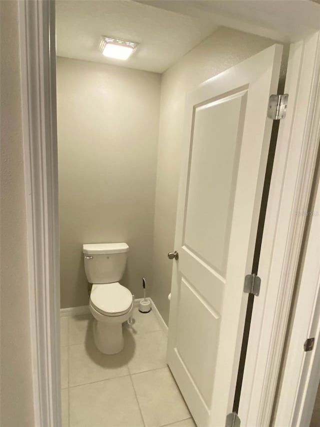 bathroom featuring tile patterned floors and toilet