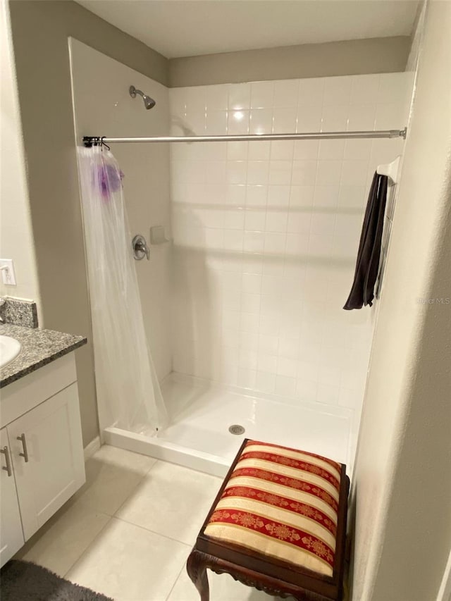 bathroom with a shower with curtain, tile patterned flooring, and vanity