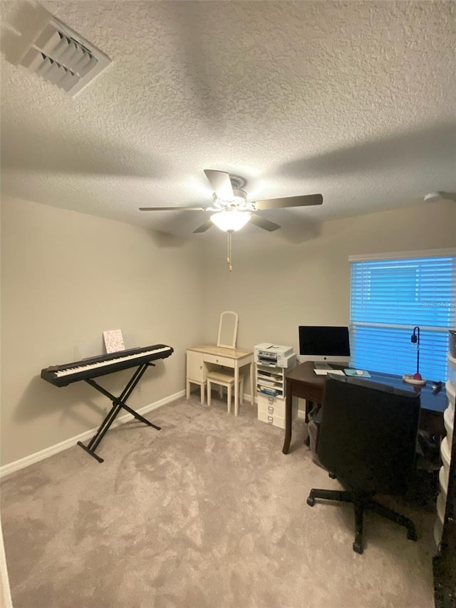 carpeted office with ceiling fan and a textured ceiling