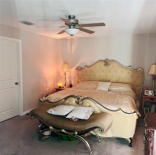 unfurnished bedroom featuring ceiling fan, carpet floors, and a textured ceiling