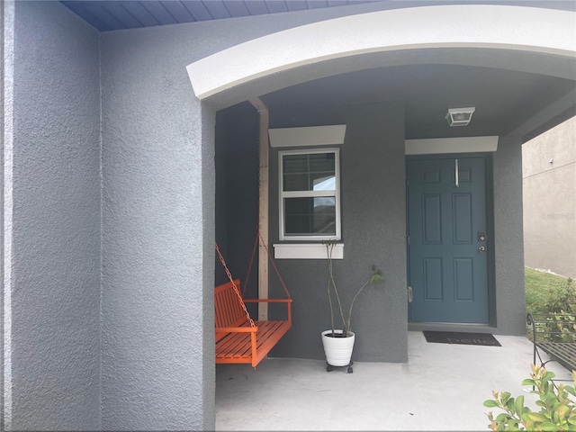 doorway to property with stucco siding