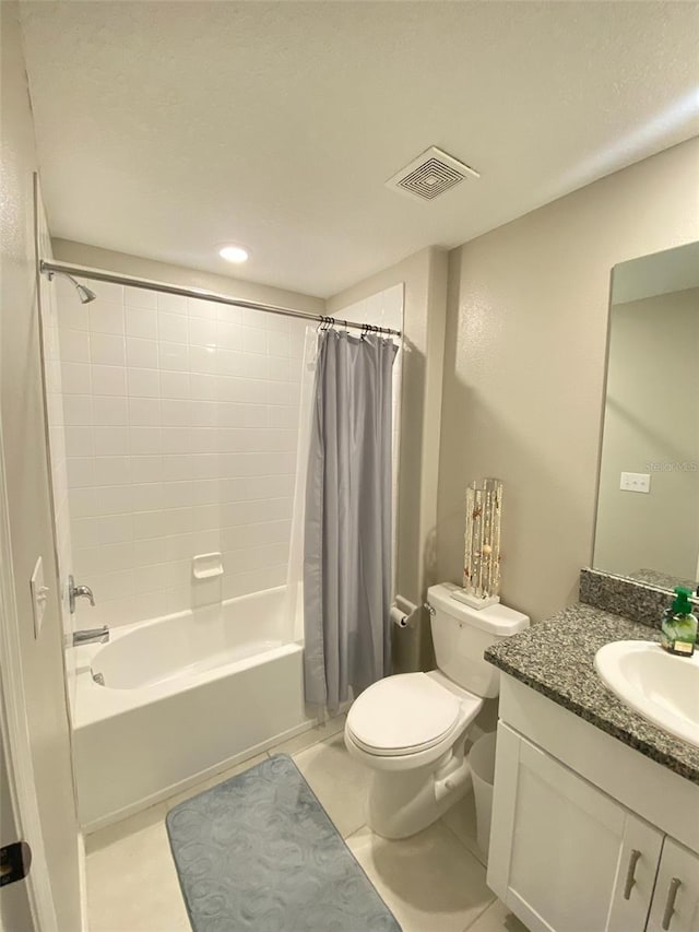 bathroom featuring visible vents, toilet, tile patterned flooring, shower / bath combo with shower curtain, and vanity