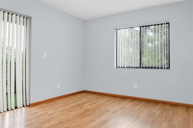 empty room with a healthy amount of sunlight and light hardwood / wood-style floors