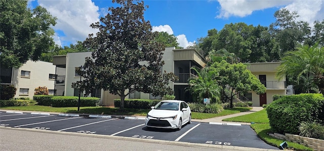 view of vehicle parking featuring a yard