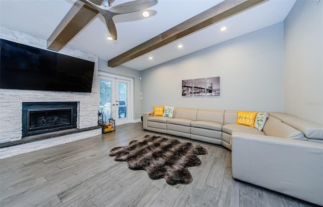 living room featuring a fireplace, french doors, wood-type flooring, ceiling fan, and vaulted ceiling with beams