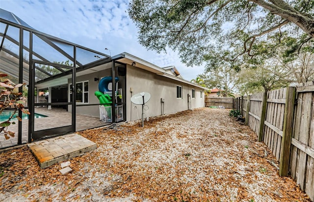 view of yard featuring a fenced in pool, a lanai, and a patio area