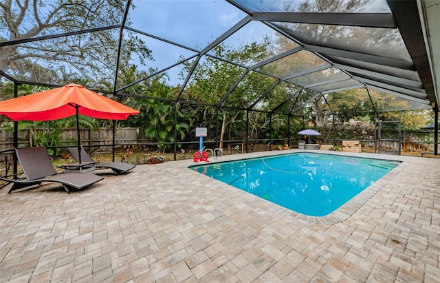 view of swimming pool with a lanai and a patio area