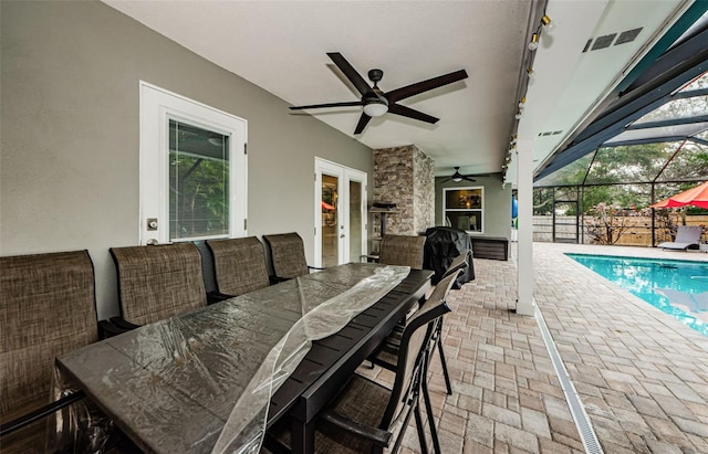 view of patio / terrace featuring french doors, a bar, a fenced in pool, glass enclosure, and ceiling fan