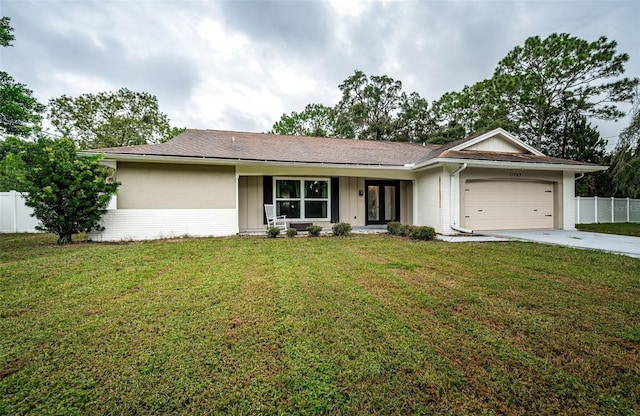 ranch-style home with a garage and a front lawn