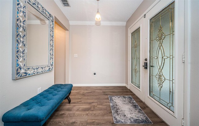 entryway featuring ornamental molding, french doors, dark hardwood / wood-style flooring, and a textured ceiling