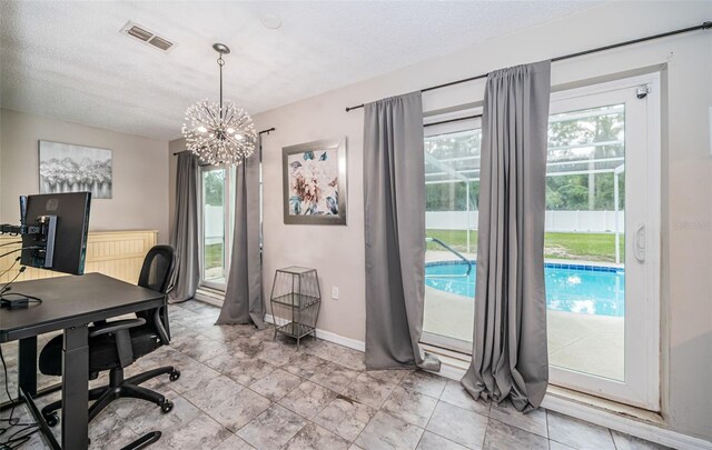 office with a textured ceiling, a notable chandelier, and light tile patterned flooring