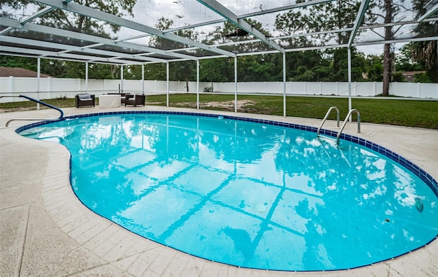 view of swimming pool with a lawn, a patio area, and glass enclosure