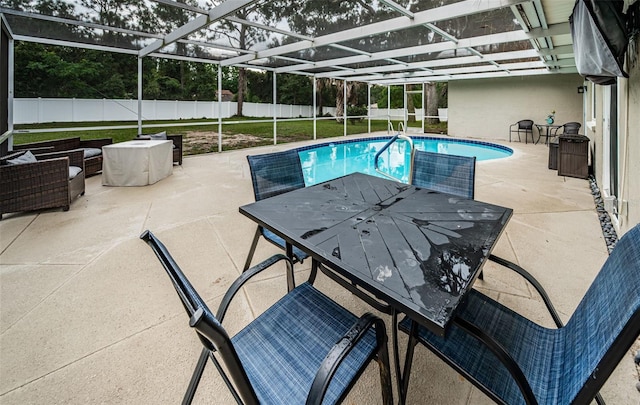 view of pool with glass enclosure, a yard, and a patio area