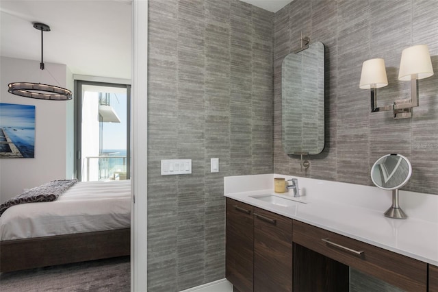 bathroom with vanity and tile walls