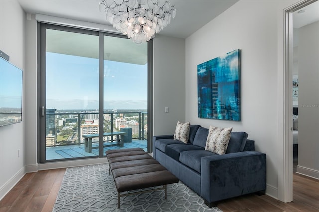 living room featuring dark hardwood / wood-style flooring, a wealth of natural light, and a chandelier