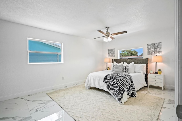 bedroom with a textured ceiling and ceiling fan