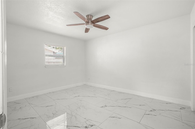 unfurnished room featuring ceiling fan and a textured ceiling