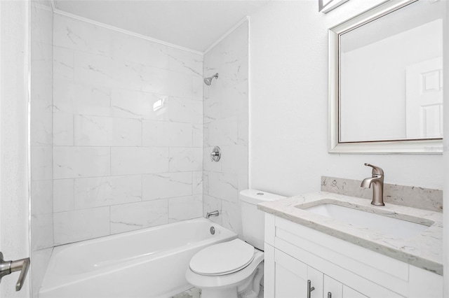 full bathroom featuring tiled shower / bath, vanity, and toilet