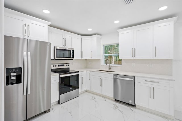 kitchen with white cabinetry, sink, and appliances with stainless steel finishes