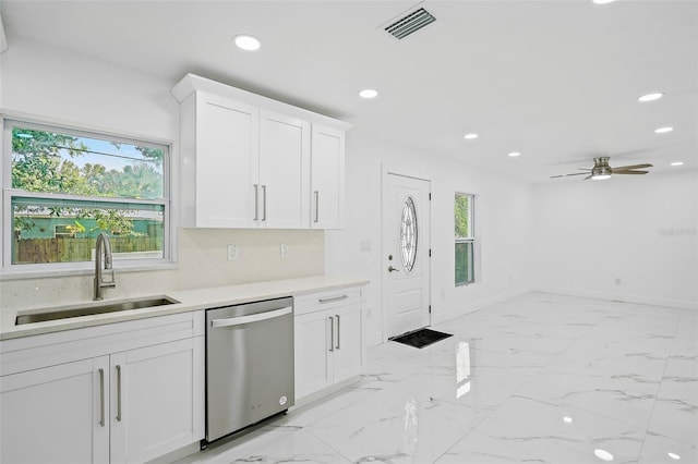 kitchen featuring white cabinets, sink, stainless steel dishwasher, ceiling fan, and decorative backsplash