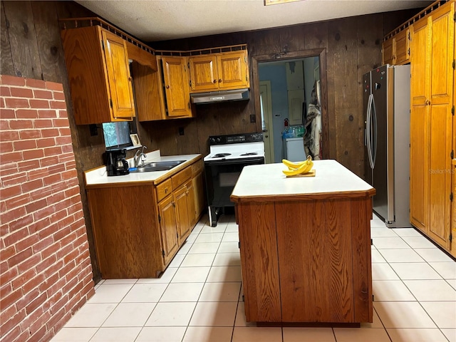 kitchen with a kitchen island, wooden walls, stainless steel refrigerator, sink, and white range with electric cooktop