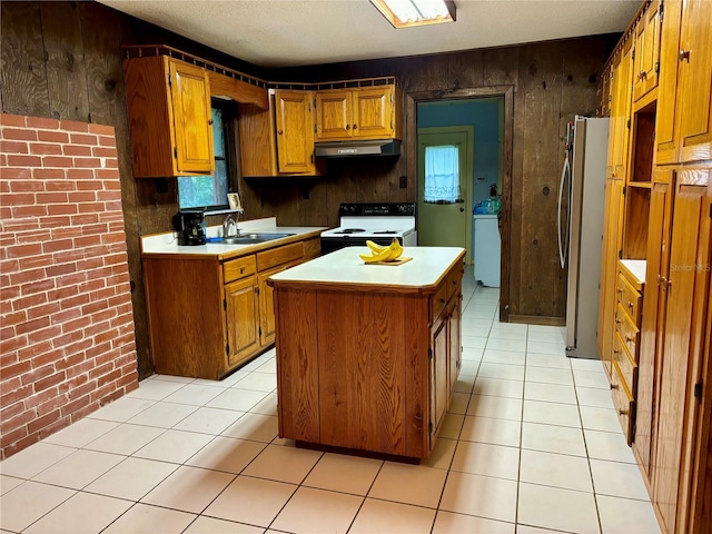 kitchen featuring a kitchen island, wooden walls, stainless steel refrigerator, sink, and white electric stove