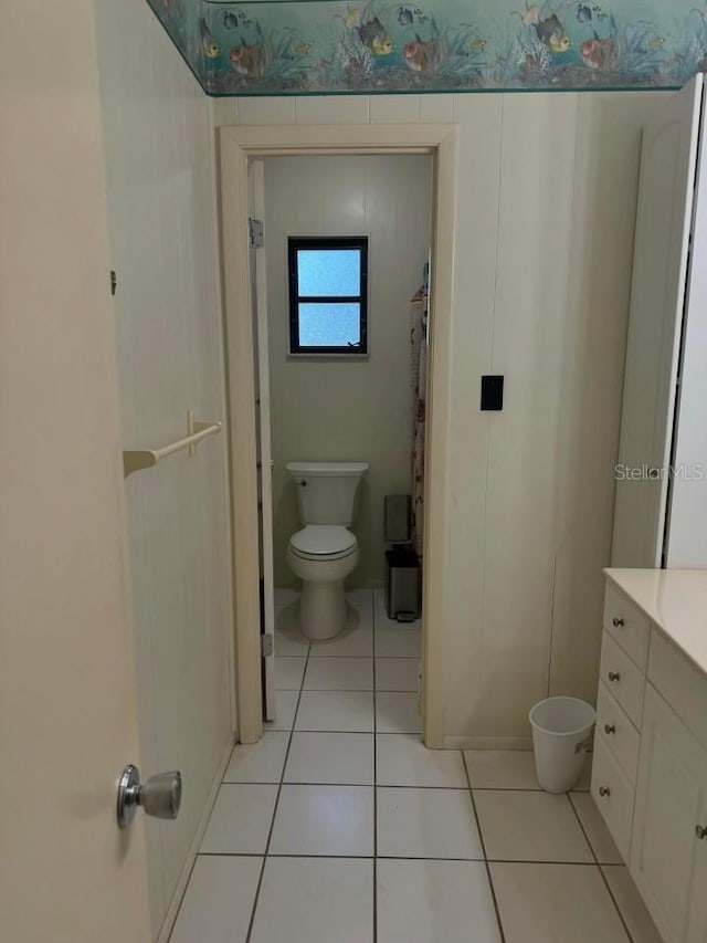 bathroom featuring tile patterned floors, toilet, and vanity