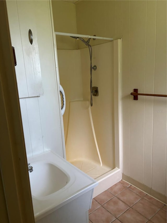 bathroom with a shower, vanity, and tile patterned floors