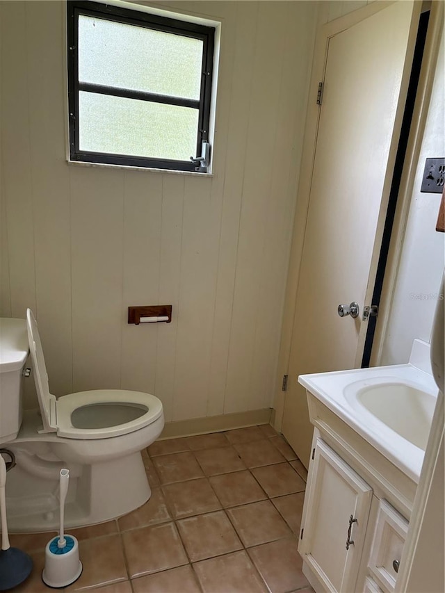 bathroom with vanity, toilet, and tile patterned floors