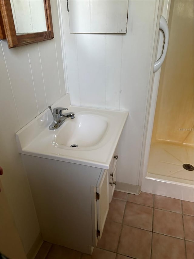 bathroom featuring vanity, walk in shower, and tile patterned floors