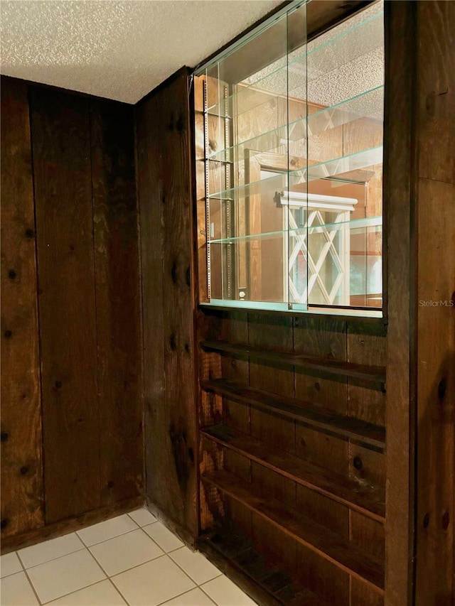 interior space featuring tile patterned flooring and a textured ceiling