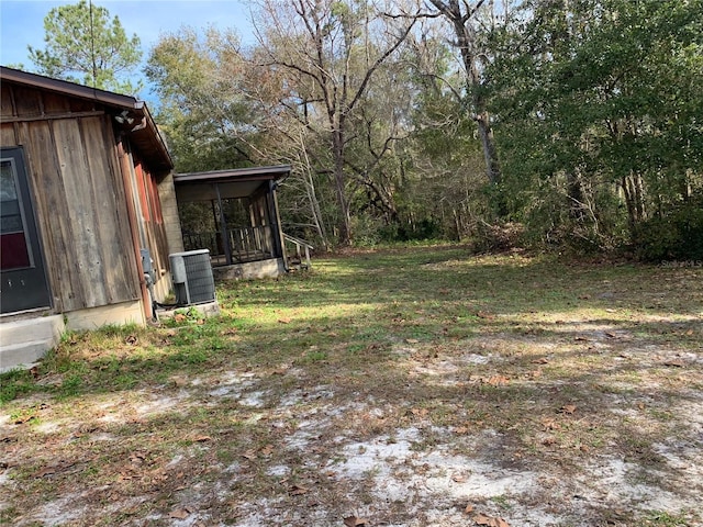 view of yard with cooling unit and a sunroom