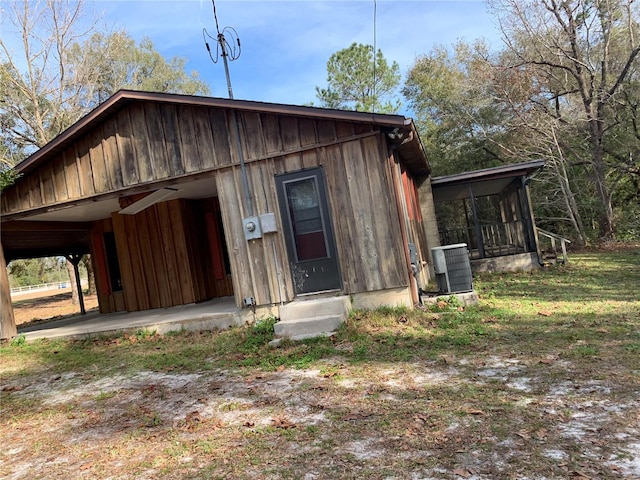 view of outdoor structure featuring a sunroom and central air condition unit