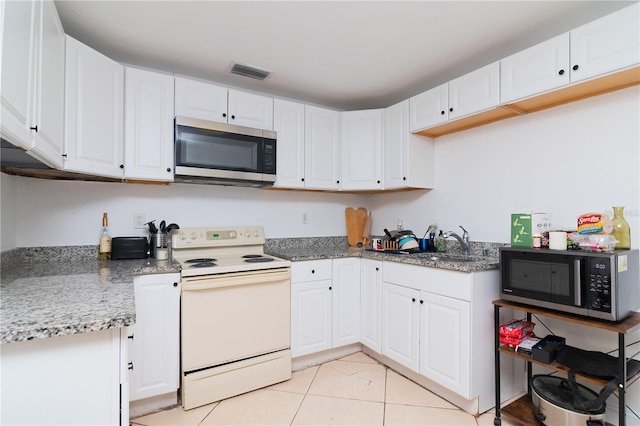 kitchen featuring sink, white cabinetry, white electric range oven, stone countertops, and light tile patterned flooring