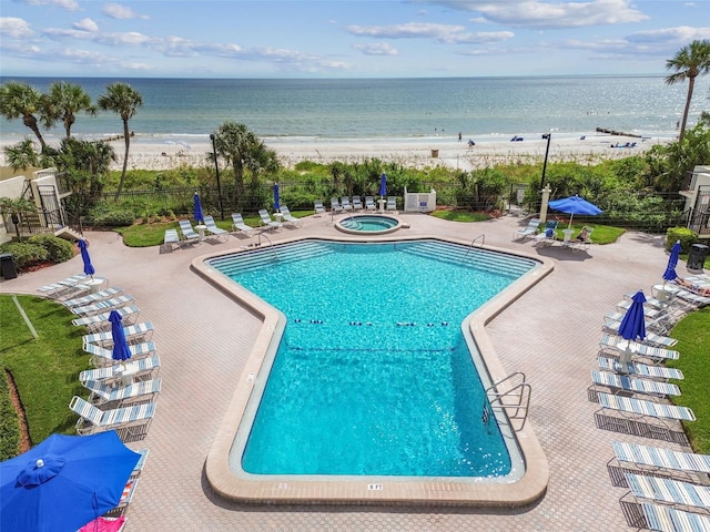 14950 Gulf Blvd Unit 404, Madeira Beach, FL 33708 - community pool with a community hot tub, view of water and beach, and a patio area