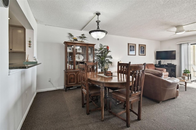 14950 Gulf Blvd Unit 404, Madeira Beach, FL 33708 - dining area featuring dark colored carpet, a textured ceiling, a ceiling fan, and baseboards