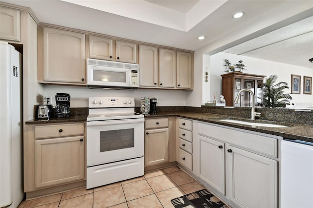 14950 Gulf Blvd Unit 404, Madeira Beach, FL 33708 - kitchen featuring white appliances, a sink, recessed lighting, light tile patterned floors, and dark stone countertops