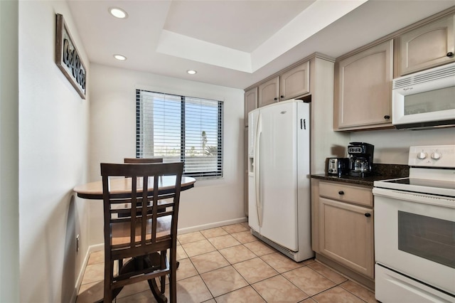 14950 Gulf Blvd Unit 404, Madeira Beach, FL 33708 - kitchen with white appliances, baseboards, recessed lighting, light tile patterned flooring, and a skylight