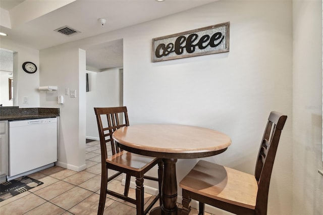 14950 Gulf Blvd Unit 404, Madeira Beach, FL 33708 - dining room with light tile patterned flooring and baseboards