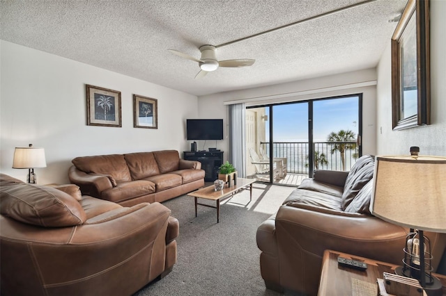 14950 Gulf Blvd Unit 404, Madeira Beach, FL 33708 - living room featuring a ceiling fan, carpet floors, and a textured ceiling